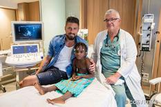 MCH-Olivier Giroud-©CCM-Philippe Fitte - Olivier Giroud, Monaco Humanitarian Collective (MCH) Ambassador, with Fanta, the 300th child to receive surgery thanks to the MCH, and Dr François Bourlon, paediatric cardiologist at the Cardiothoracic Centre. © CCM/Philippe Fitte