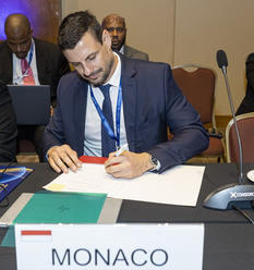 Signature déclaration dépôt addendum AMAC NCD © DR - Romain Bugnicourt, Head of Division, Ministry of Finance and Economy, signing the declaration submitting the Addendum to the MCAA. © DR